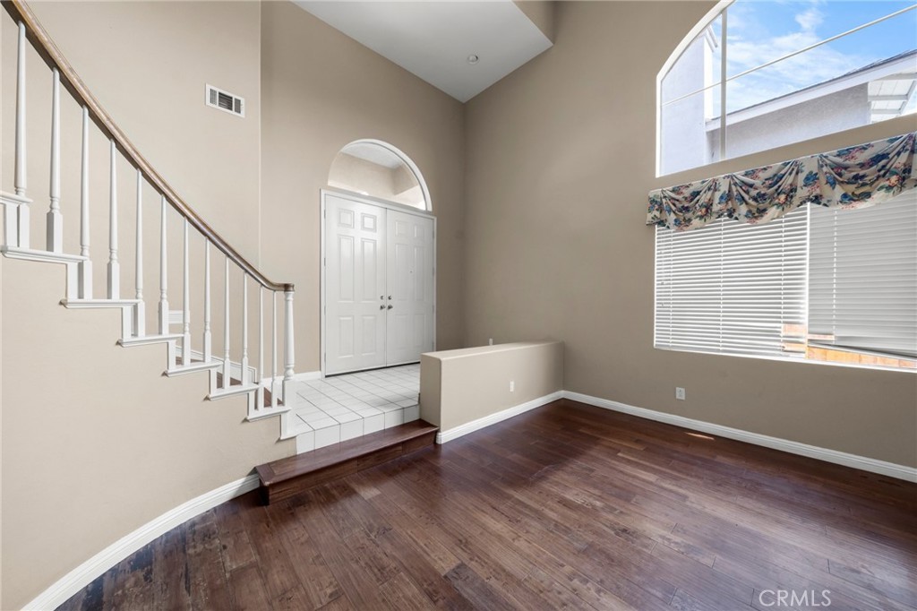 7116 Sapri Place Rancho Cucamonga, CA 91701 - Photo 17 of 52 a view of entryway with stairs and wooden floor