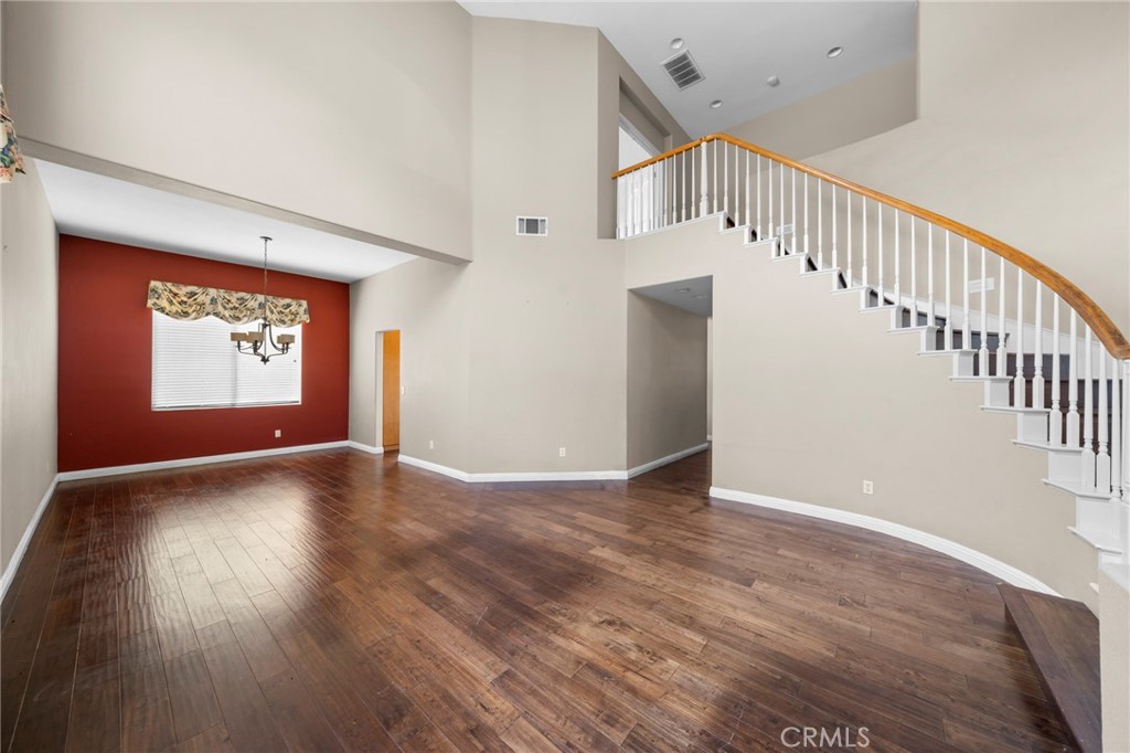 7116 Sapri Place Rancho Cucamonga, CA 91701 - Photo 19 of 52 a view of an empty room with wooden floor and windows