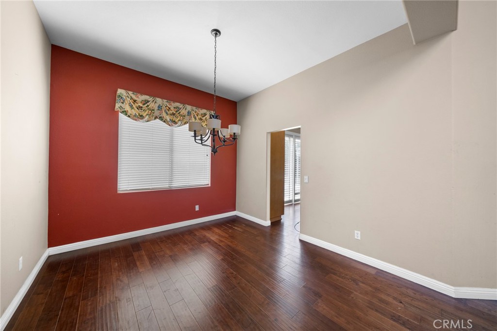 7116 Sapri Place Rancho Cucamonga, CA 91701 - Photo 20 of 52 a view of an empty room with wooden floor and a window