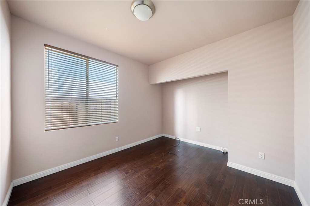 7116 Sapri Place Rancho Cucamonga, CA 91701 - Photo 21 of 52 an empty room with wooden floor and windows