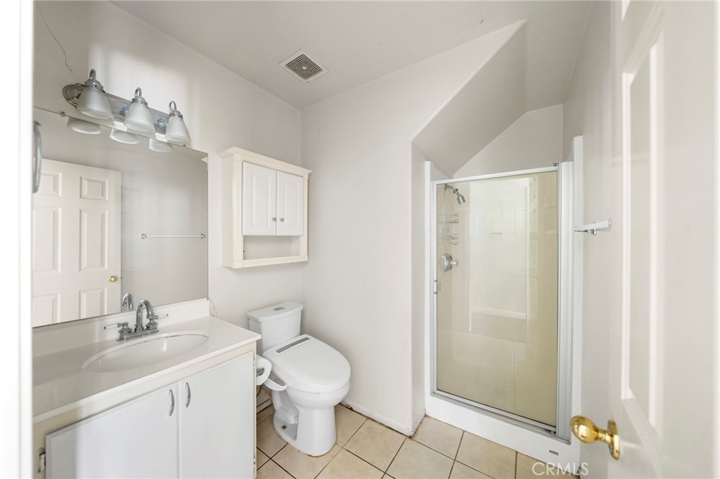 7116 Sapri Place Rancho Cucamonga, CA 91701 - Photo 23 of 52 a bathroom with a toilet a sink and mirror