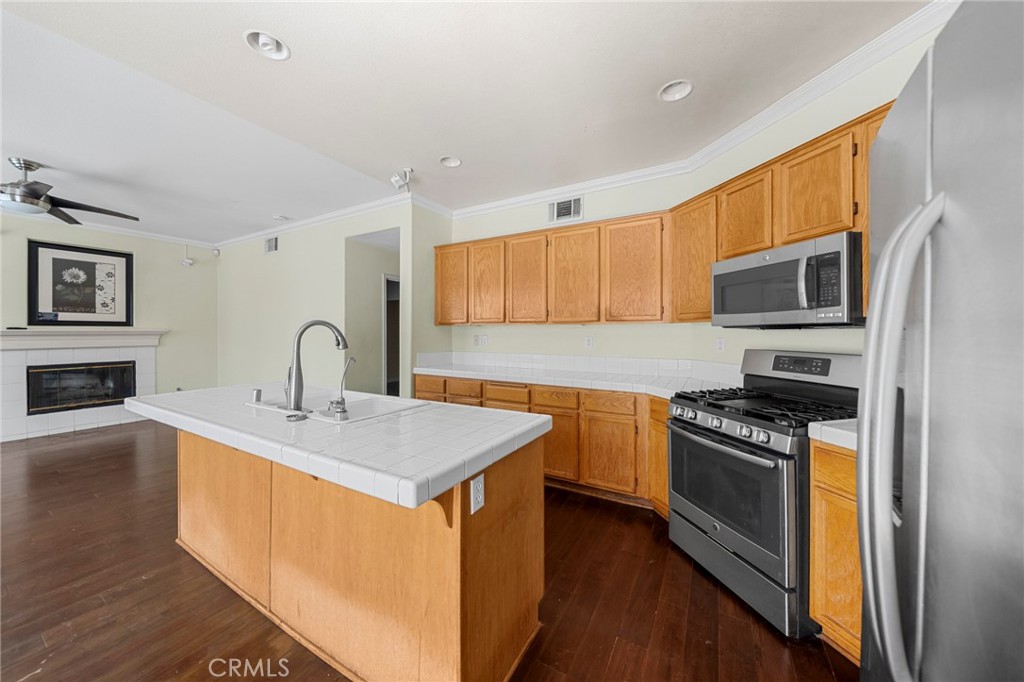 7116 Sapri Place Rancho Cucamonga, CA 91701 - Photo 31 of 52 a kitchen with stainless steel appliances granite countertop a sink stove microwave and refrigerator