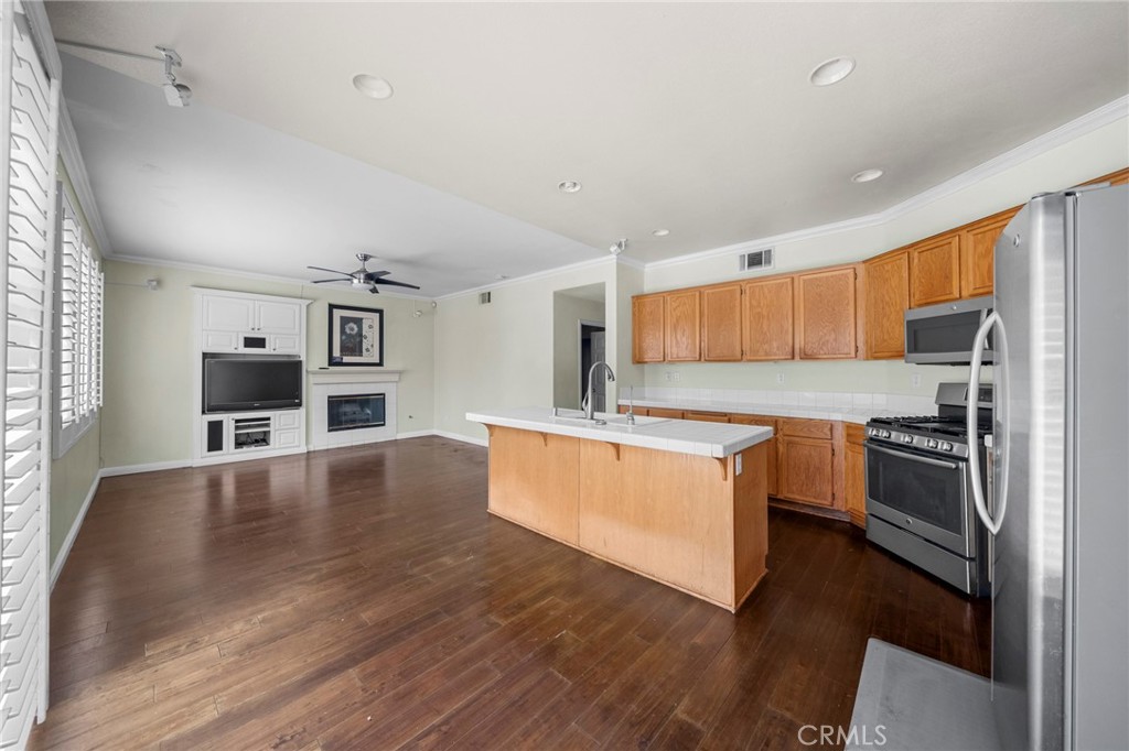 7116 Sapri Place Rancho Cucamonga, CA 91701 - Photo 32 of 52 a kitchen with stainless steel appliances a refrigerator and a stove top oven