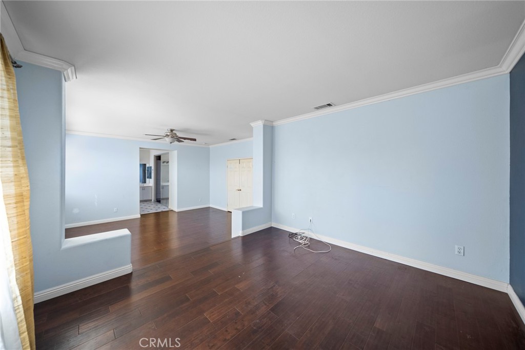 7116 Sapri Place Rancho Cucamonga, CA 91701 - Photo 37 of 52 an empty room with wooden floor and windows