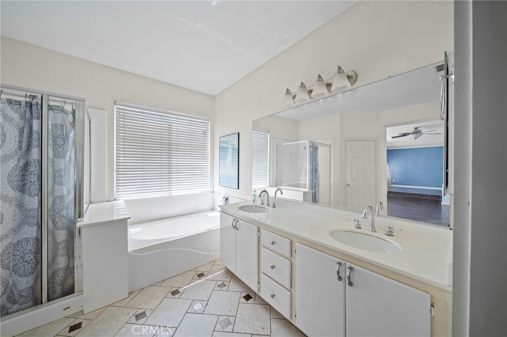 7116 Sapri Place Rancho Cucamonga, CA 91701 - Photo 39 of 52 a bathroom with a sink double vanity mirror and a bathtub