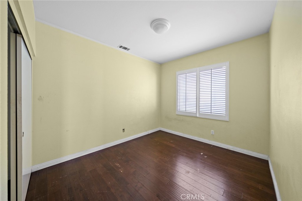 7116 Sapri Place Rancho Cucamonga, CA 91701 - Photo 41 of 52 an empty room with wooden floor and windows