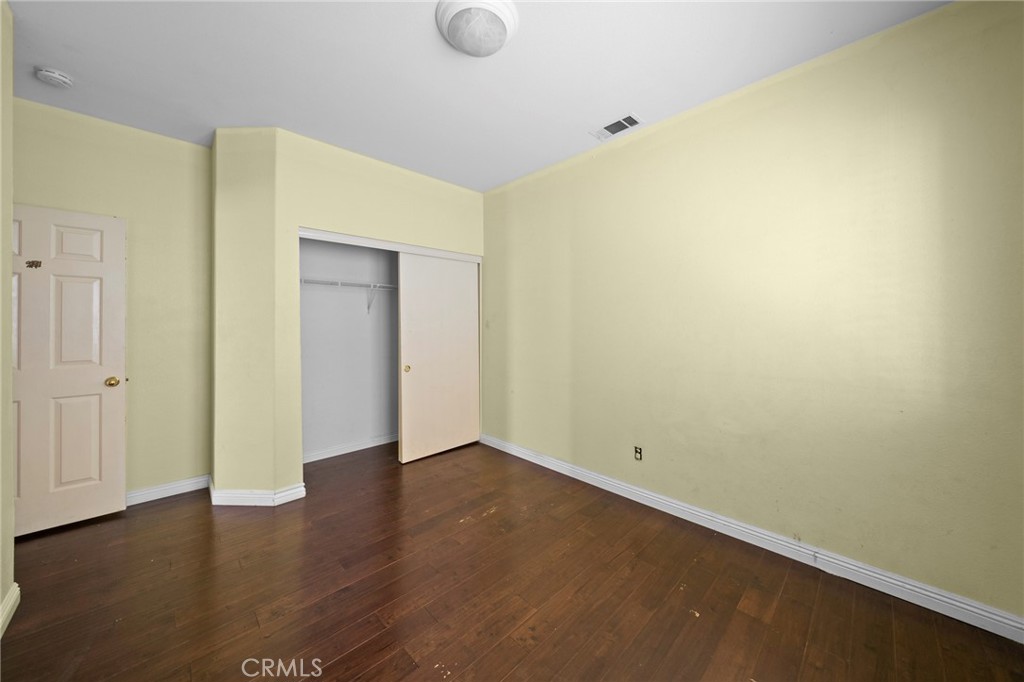 7116 Sapri Place Rancho Cucamonga, CA 91701 - Photo 42 of 52 a view of an empty room with wooden floor