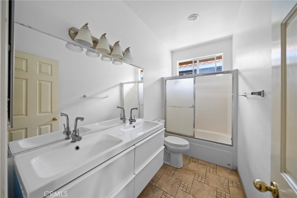 7116 Sapri Place Rancho Cucamonga, CA 91701 - Photo 43 of 52 a bathroom with a double vanity sink mirror and toilet