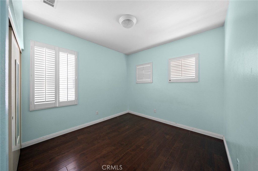 7116 Sapri Place Rancho Cucamonga, CA 91701 - Photo 44 of 52 an empty room with wooden floor and windows