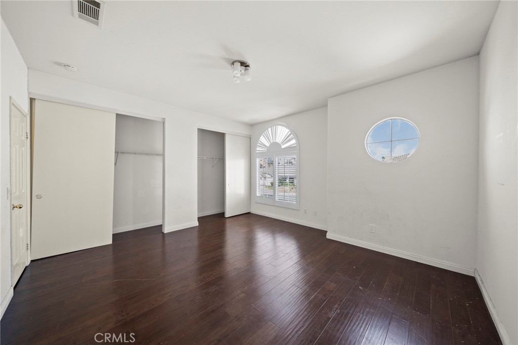 7116 Sapri Place Rancho Cucamonga, CA 91701 - Photo 47 of 52 a view of an empty room with wooden floor