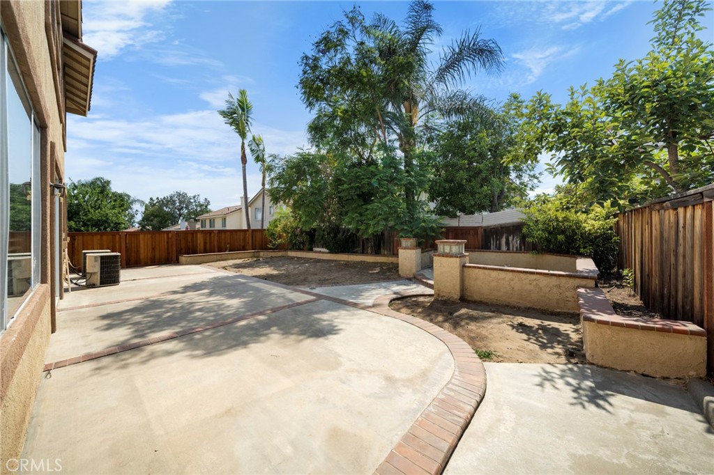 7116 Sapri Place Rancho Cucamonga, CA 91701 - Photo 49 of 52 a view of a backyard with couches chair and wooden fence