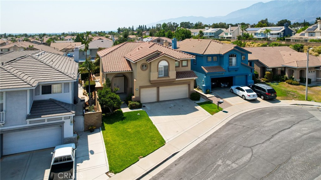 7116 Sapri Place Rancho Cucamonga, CA 91701 - Photo 5 of 52 a view of a big house with a big yard and large trees
