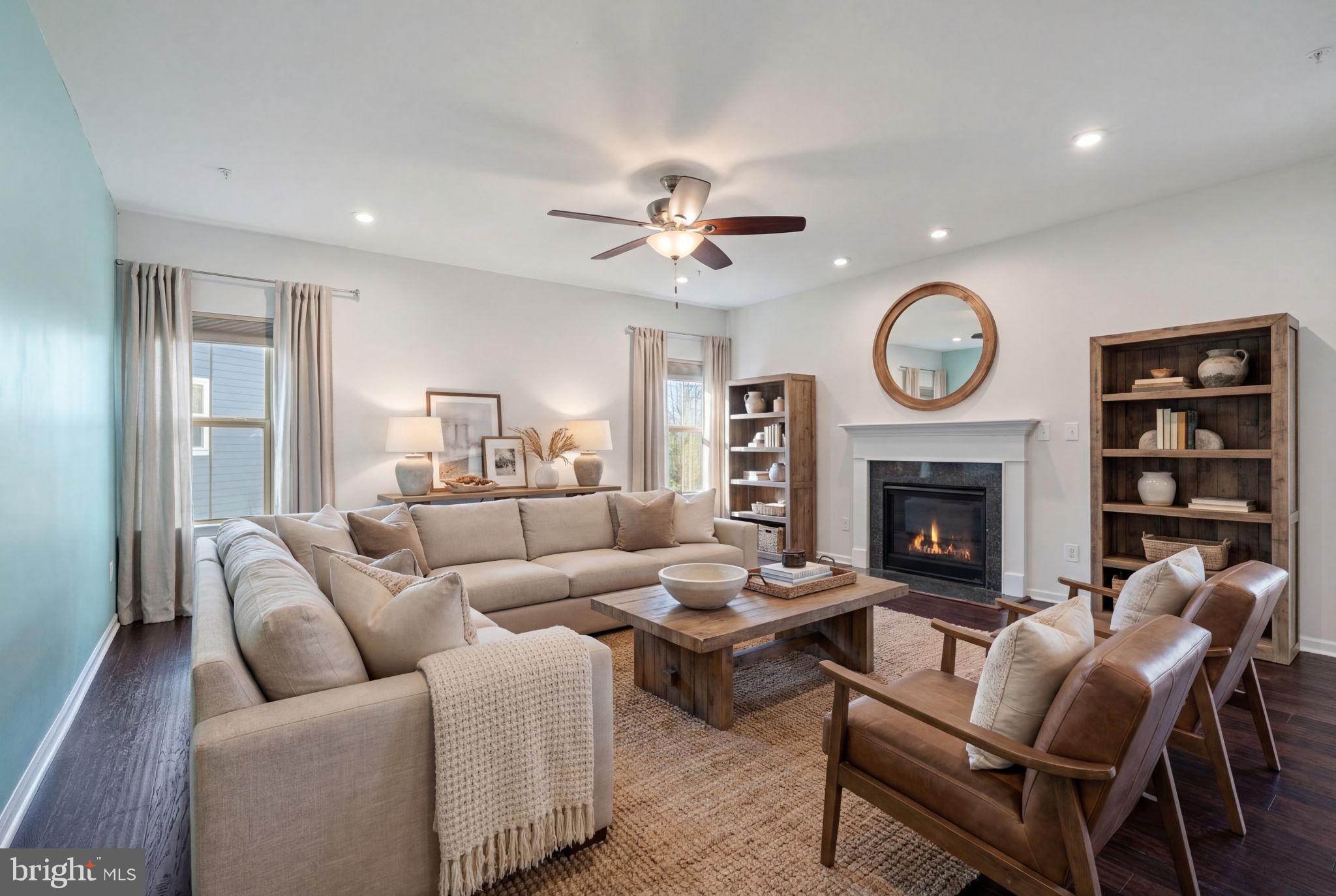 2044 Scarlet Pine Road Dumfries, VA 22026 - Photo 11 of 85 a living room with furniture a clock and a fireplace