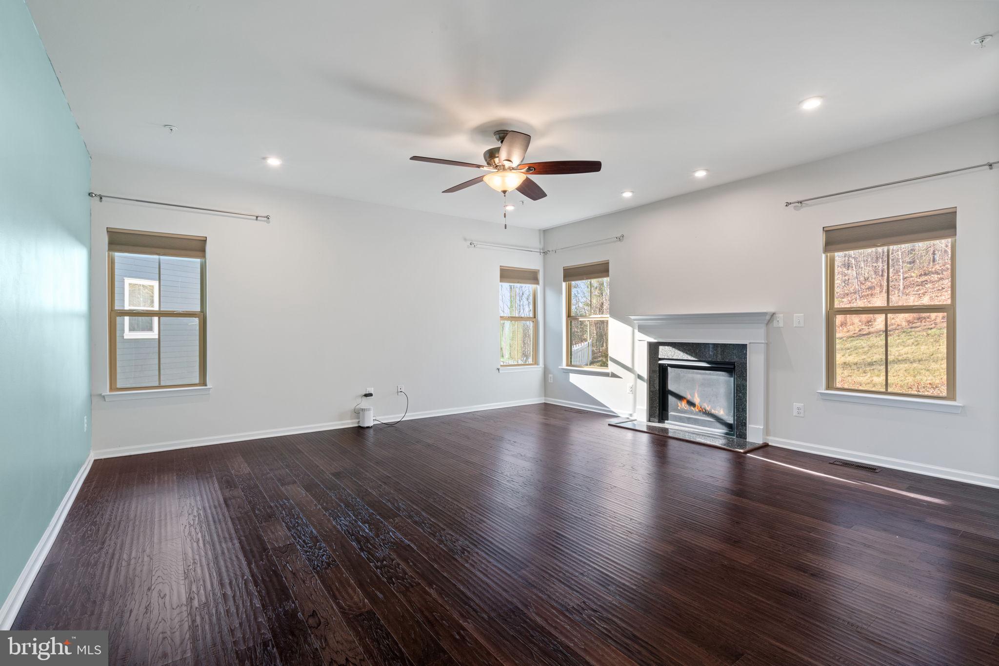 2044 Scarlet Pine Road Dumfries, VA 22026 - Photo 12 of 85 a view of an empty room with wooden floor and a window