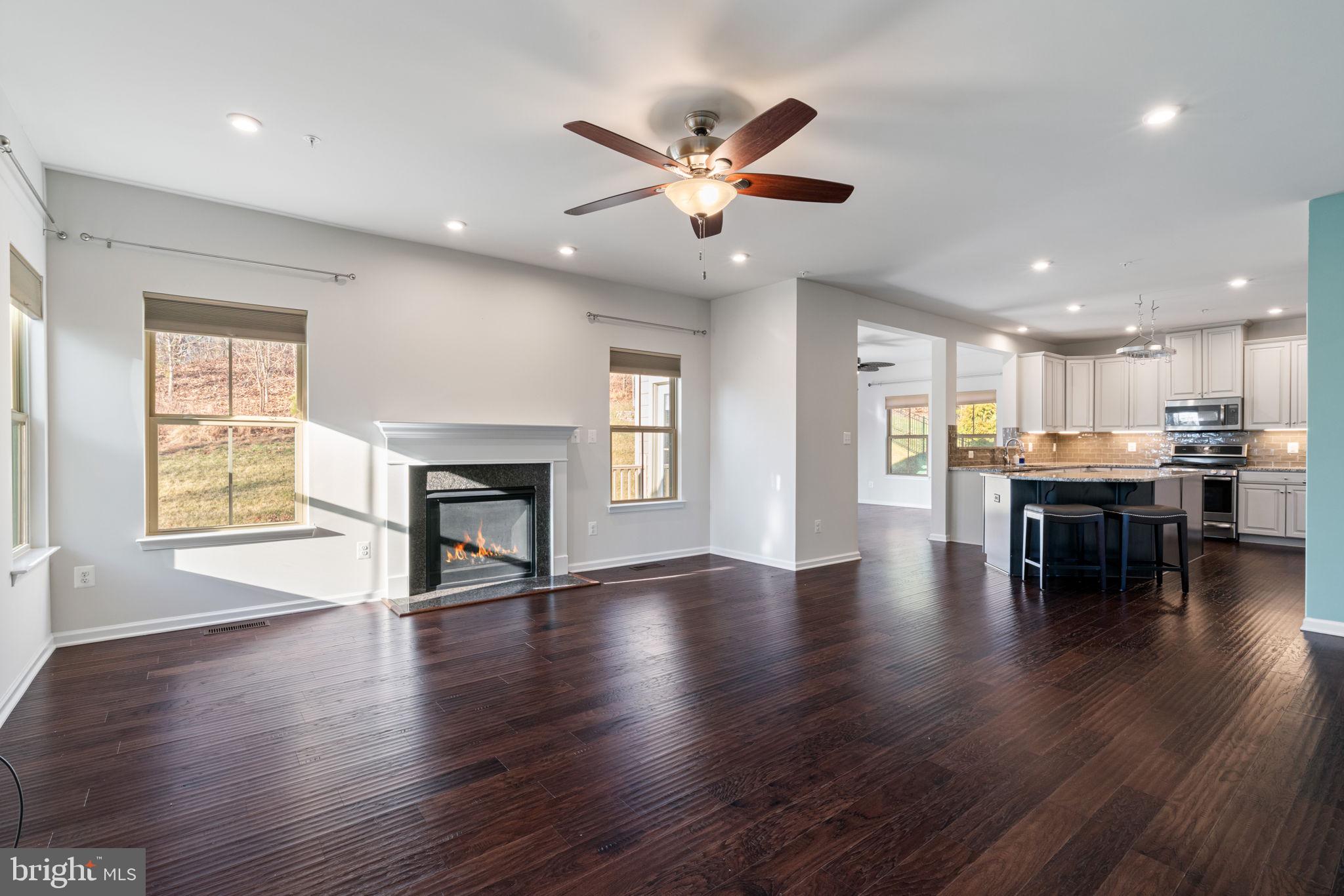 2044 Scarlet Pine Road Dumfries, VA 22026 - Photo 13 of 85 a view of an empty room with wooden floor and a window