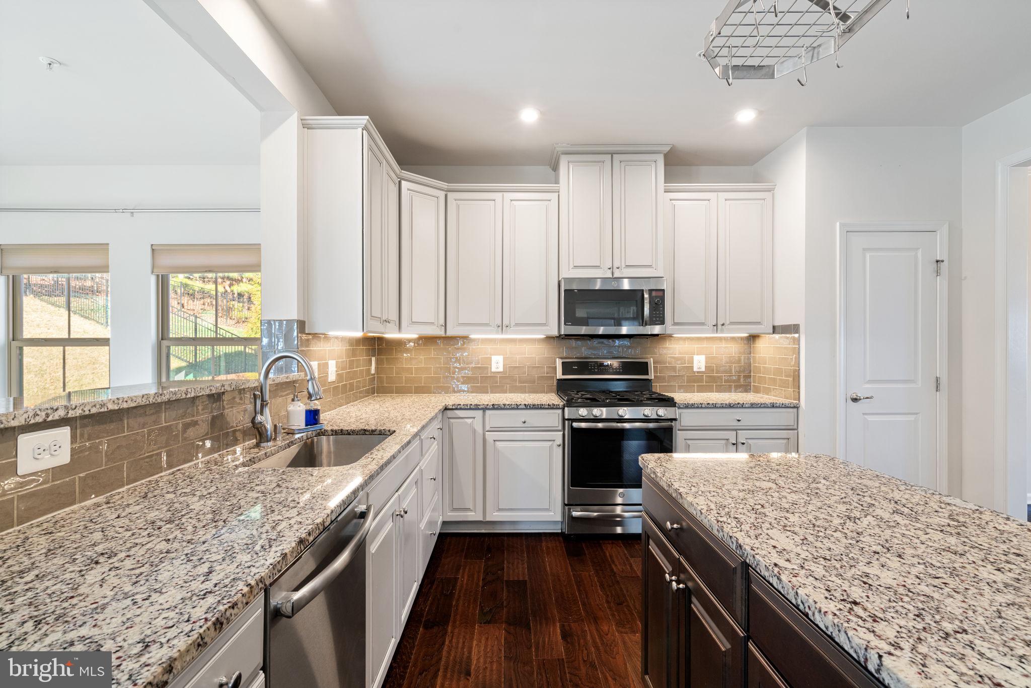 2044 Scarlet Pine Road Dumfries, VA 22026 - Photo 17 of 85 a kitchen with a sink stove and cabinets