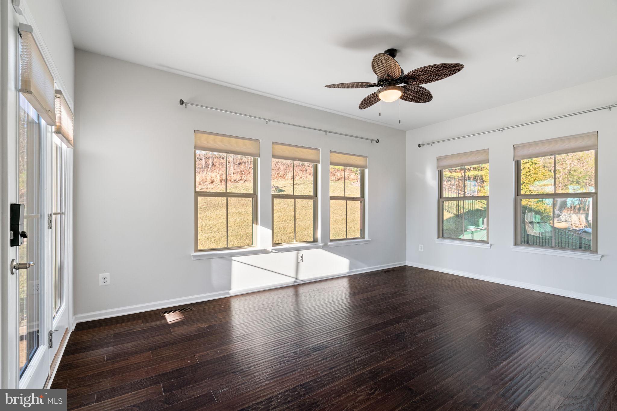 2044 Scarlet Pine Road Dumfries, VA 22026 - Photo 21 of 85 a view of an empty room with wooden floor and a window