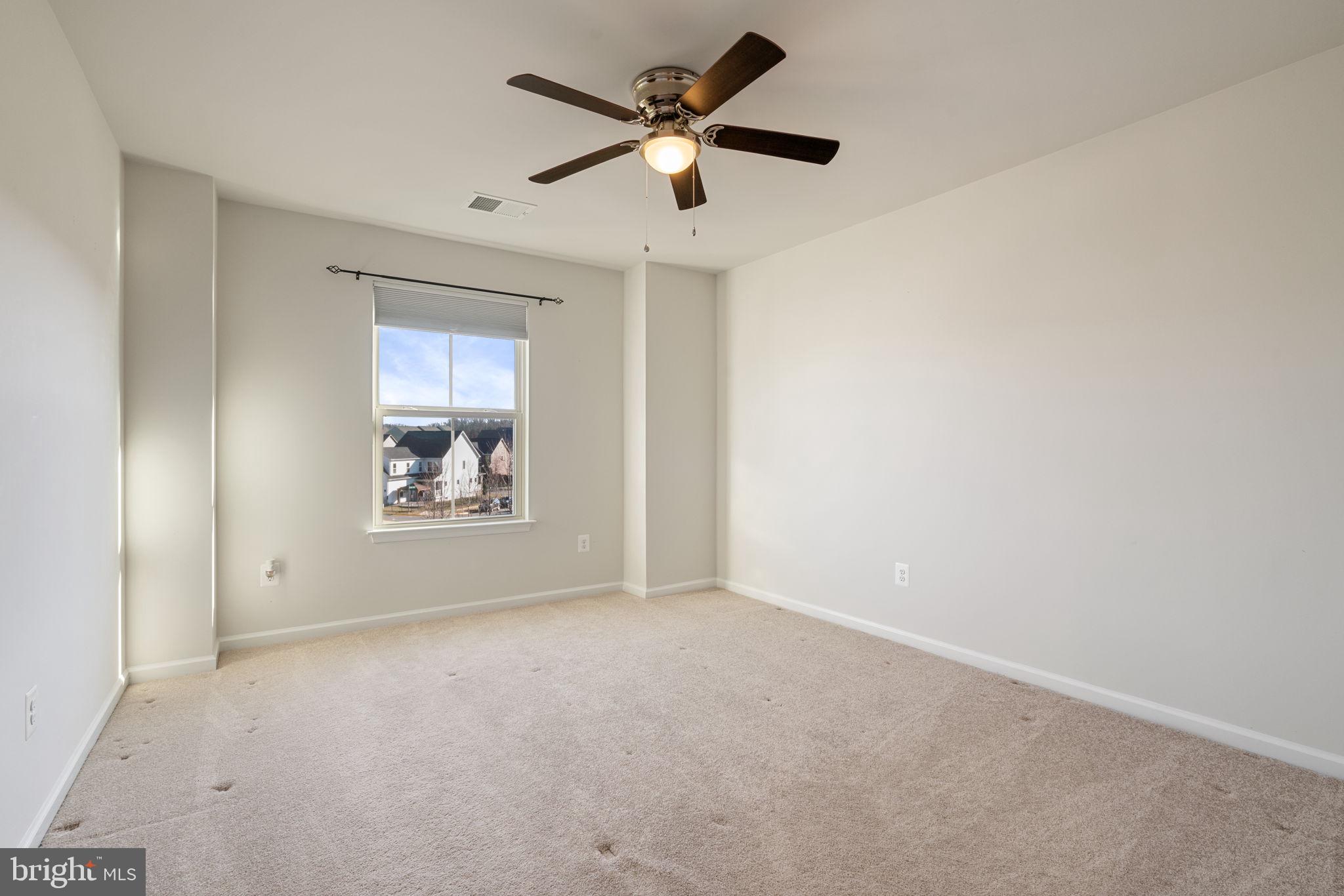2044 Scarlet Pine Road Dumfries, VA 22026 - Photo 34 of 85 a view of an empty room with window and a ceiling fan