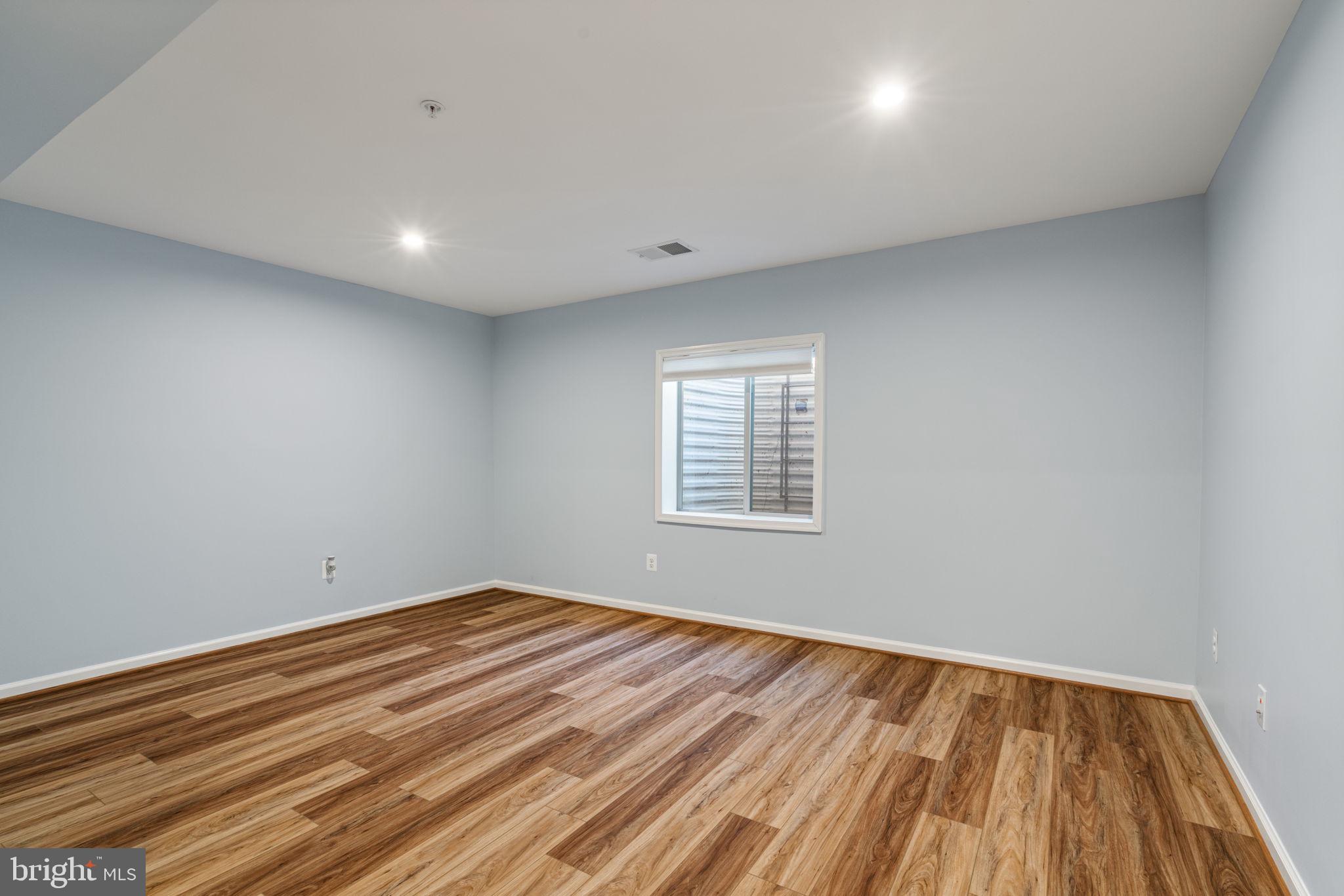 2044 Scarlet Pine Road Dumfries, VA 22026 - Photo 39 of 85 an empty room with wooden floor and windows
