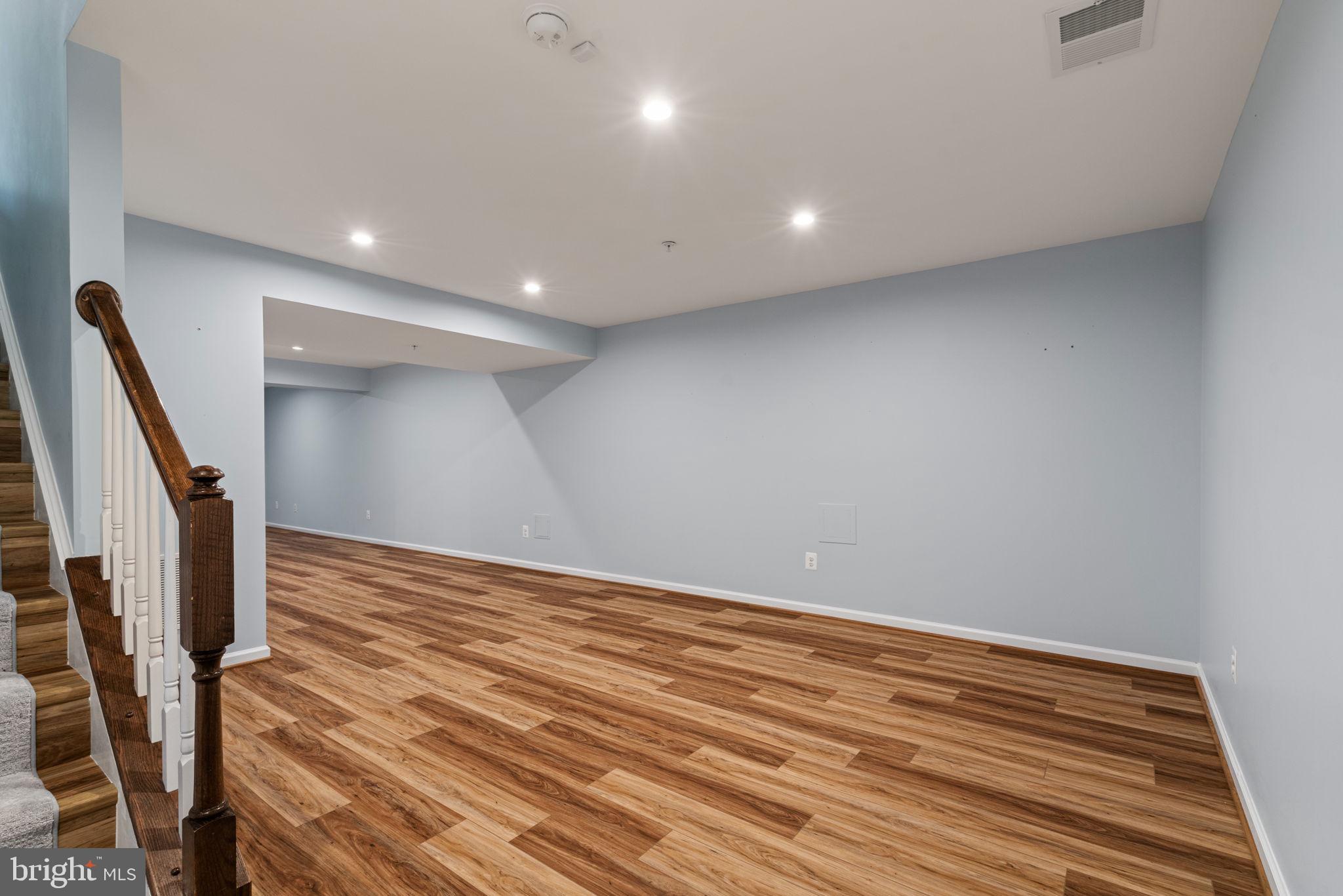 2044 Scarlet Pine Road Dumfries, VA 22026 - Photo 42 of 85 a view of a room with wooden floor and stairs