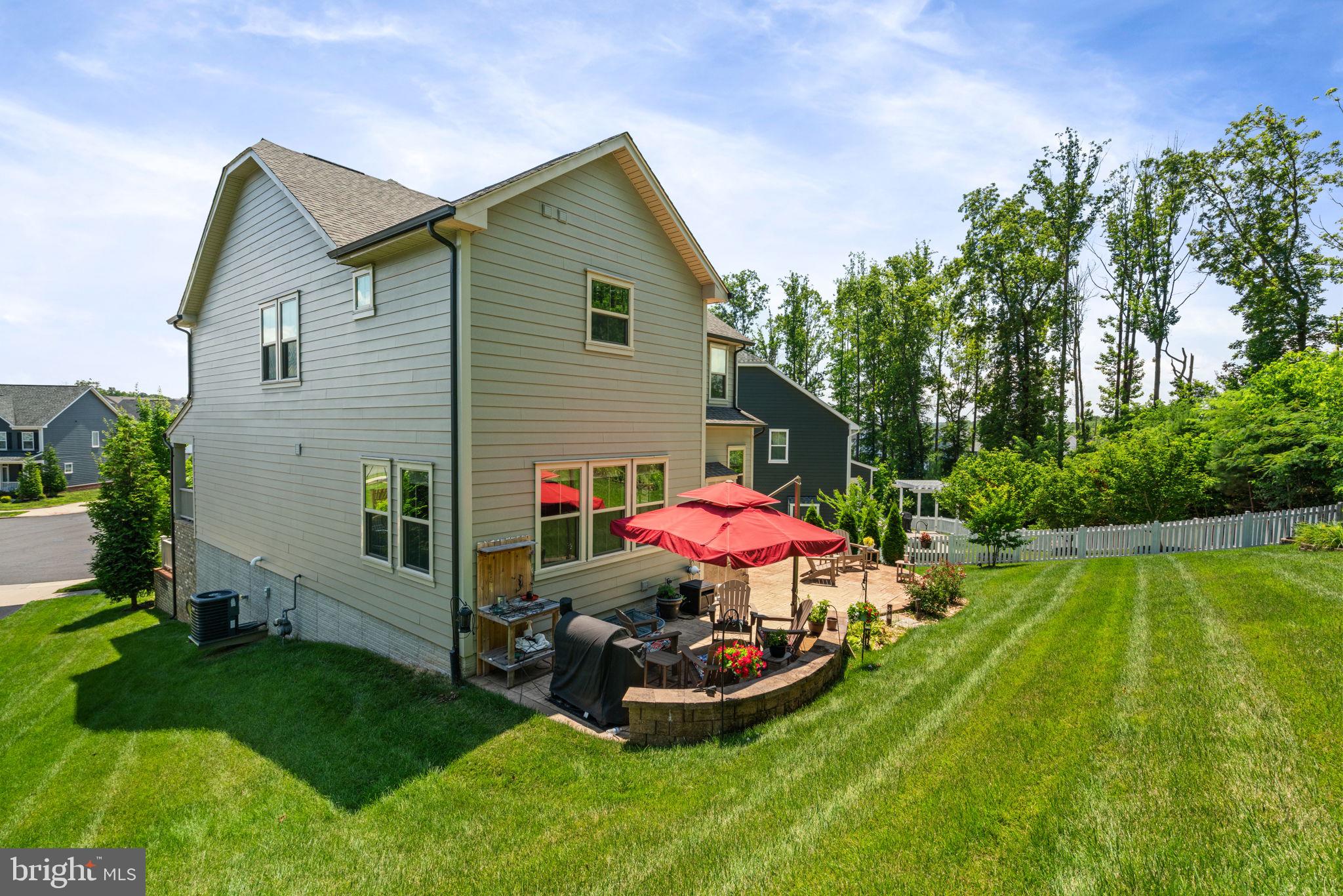 2044 Scarlet Pine Road Dumfries, VA 22026 - Photo 58 of 85 a view of a house with backyard sitting area and garden