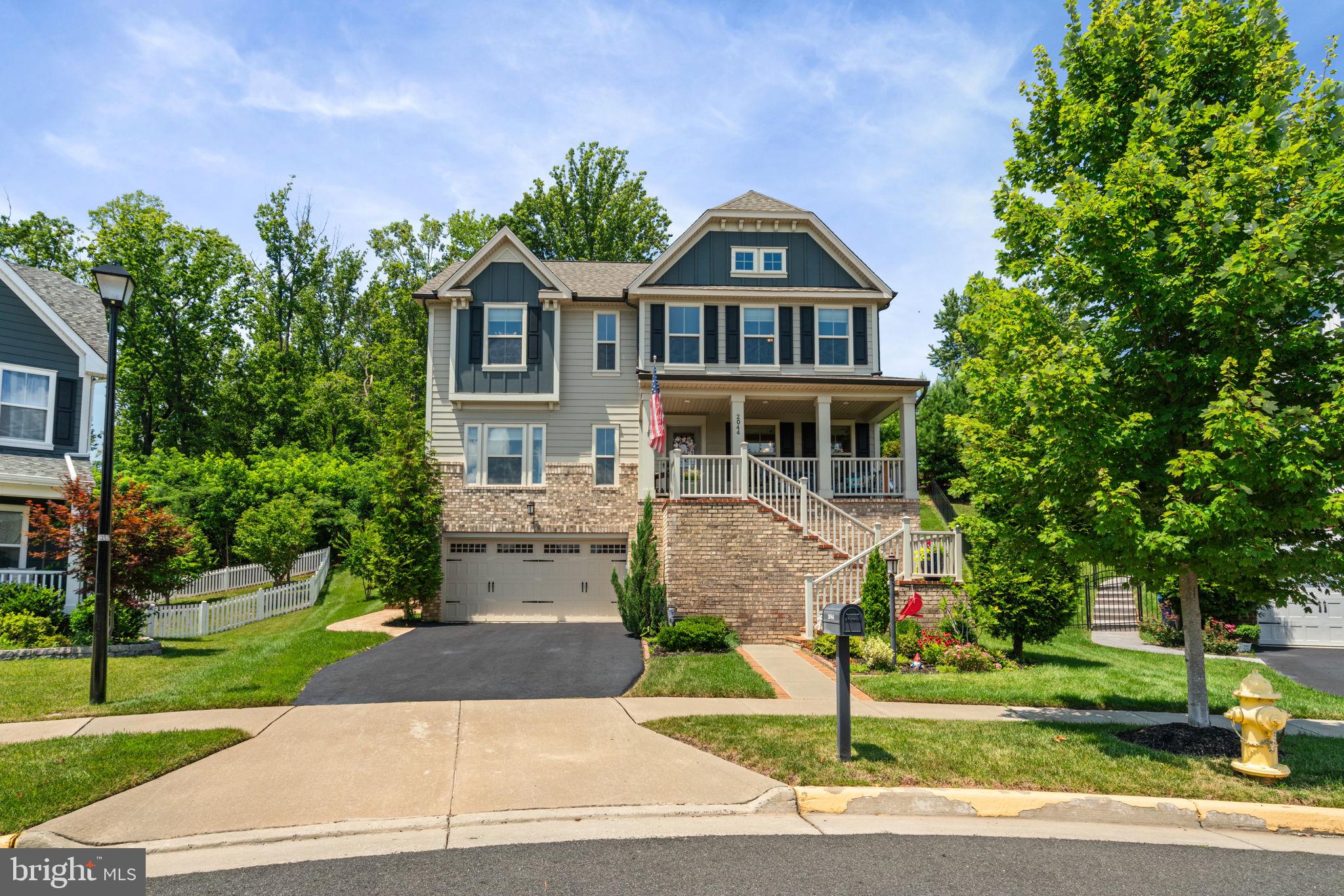 2044 Scarlet Pine Road Dumfries, VA 22026 - Photo 60 of 85 a front view of a house with a yard