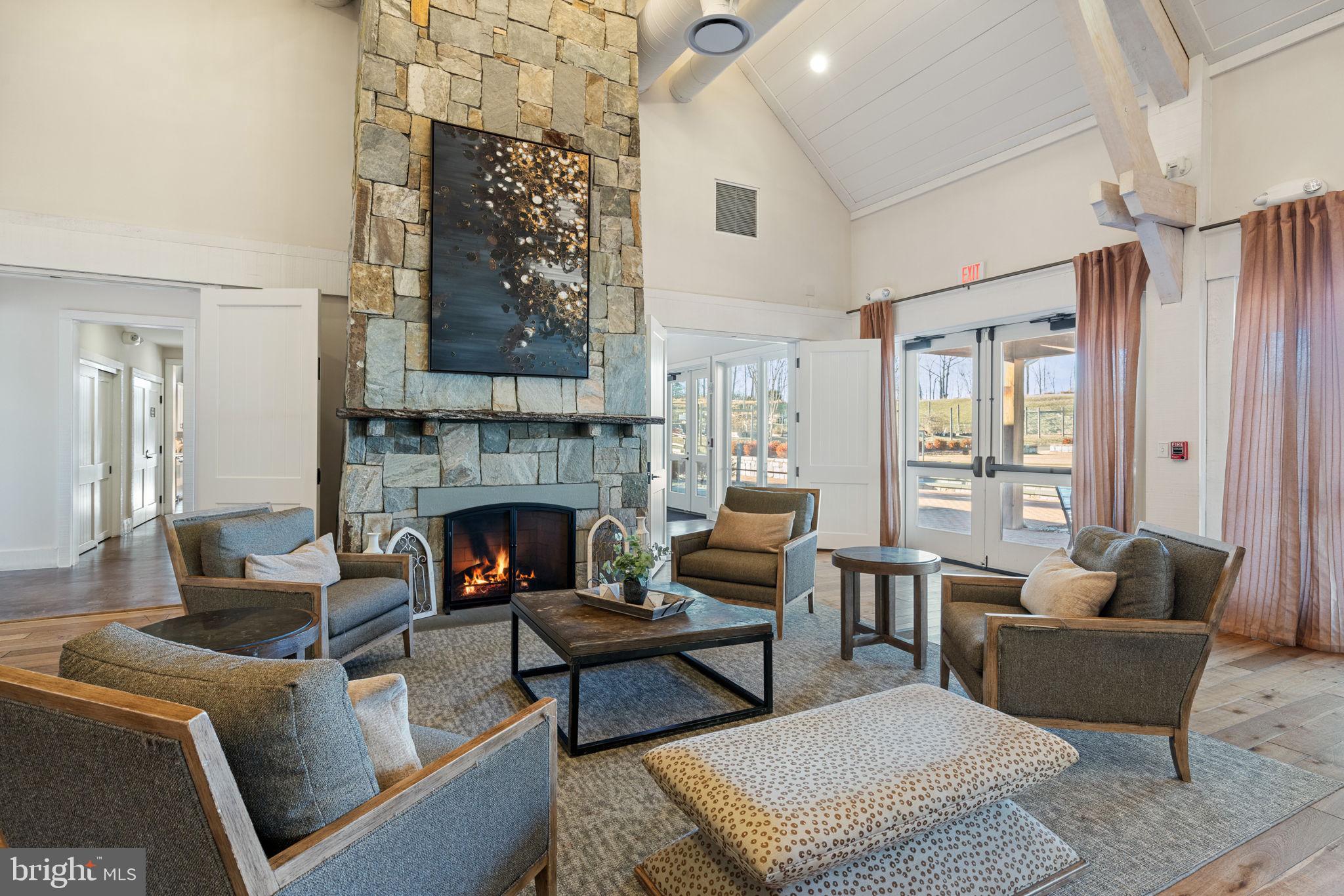 2044 Scarlet Pine Road Dumfries, VA 22026 - Photo 71 of 85 a living room with furniture a fireplace and a table