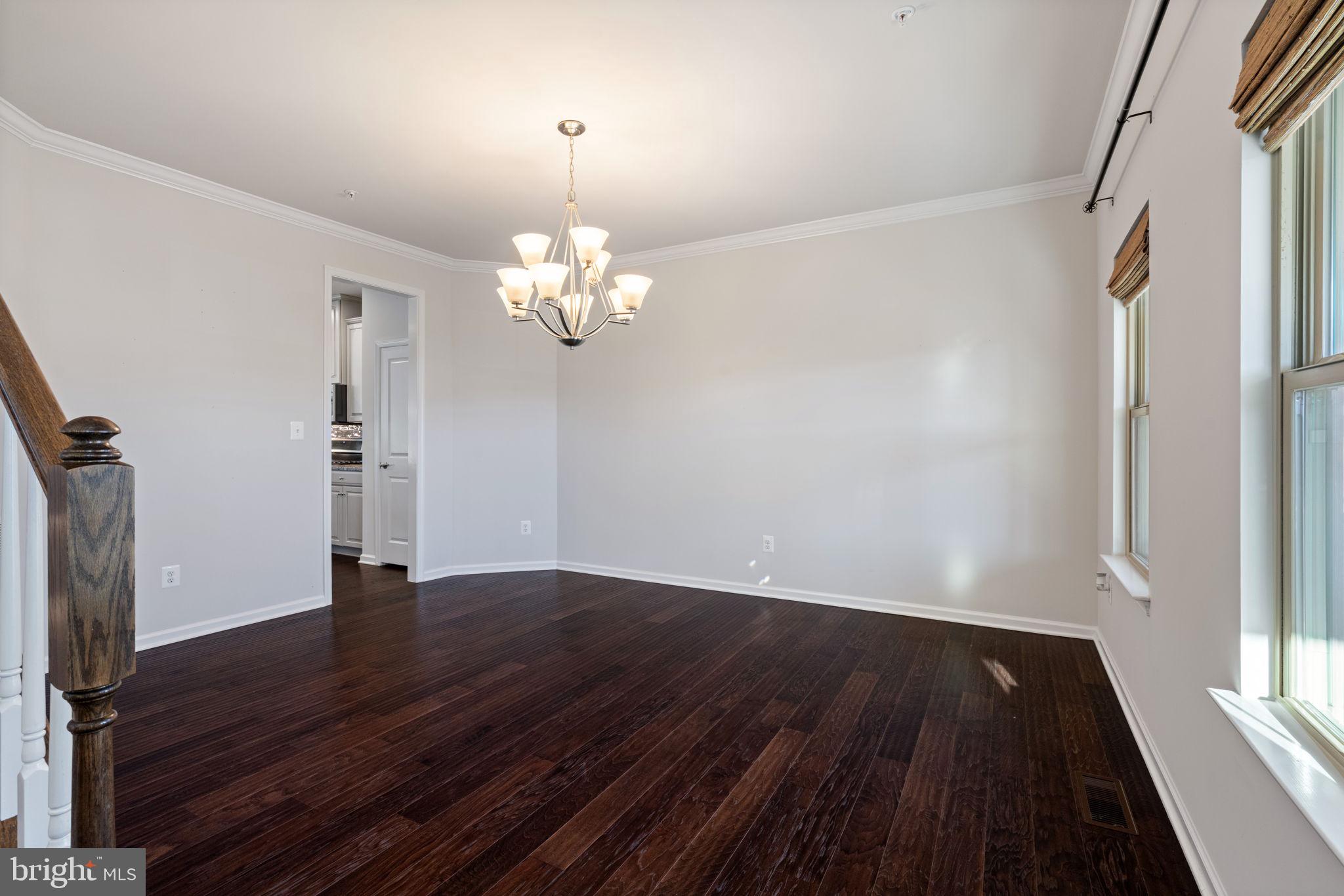 2044 Scarlet Pine Road Dumfries, VA 22026 - Photo 8 of 85 a view of empty room with wooden floor and fan