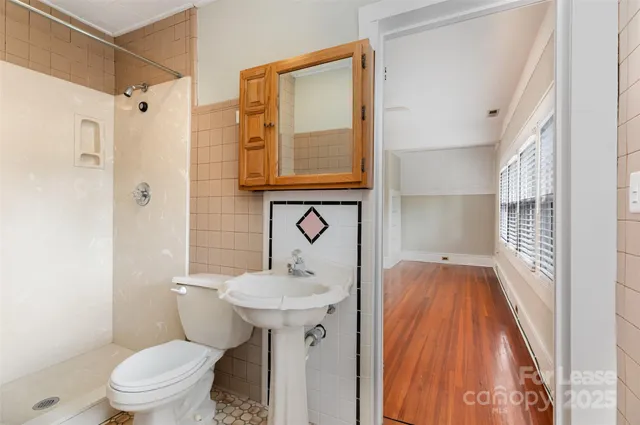 a bathroom with a sink toilet and shower