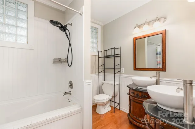 a bathroom with a sink toilet a mirror and shower