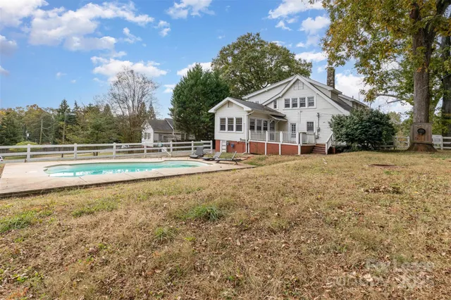 a front view of a house with a yard and lake view