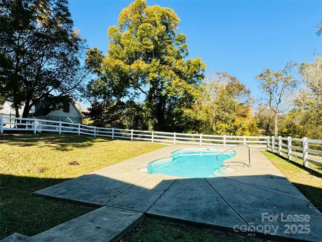 a view of a swimming pool with an outdoor seating