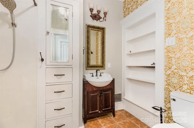 a bathroom with a sink a mirror and a shower