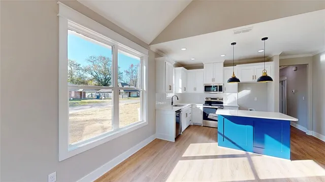 a kitchen with a refrigerator and a sink