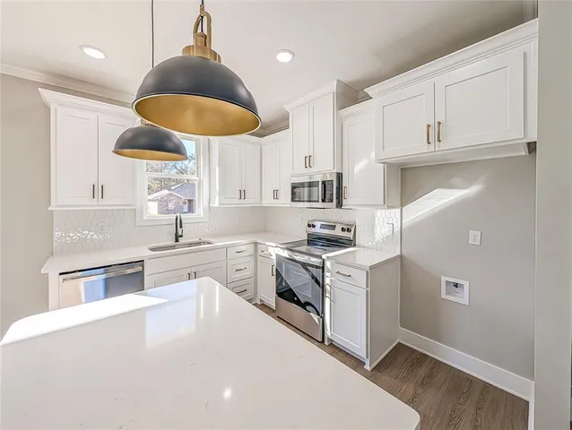 a kitchen with a sink stove and cabinets