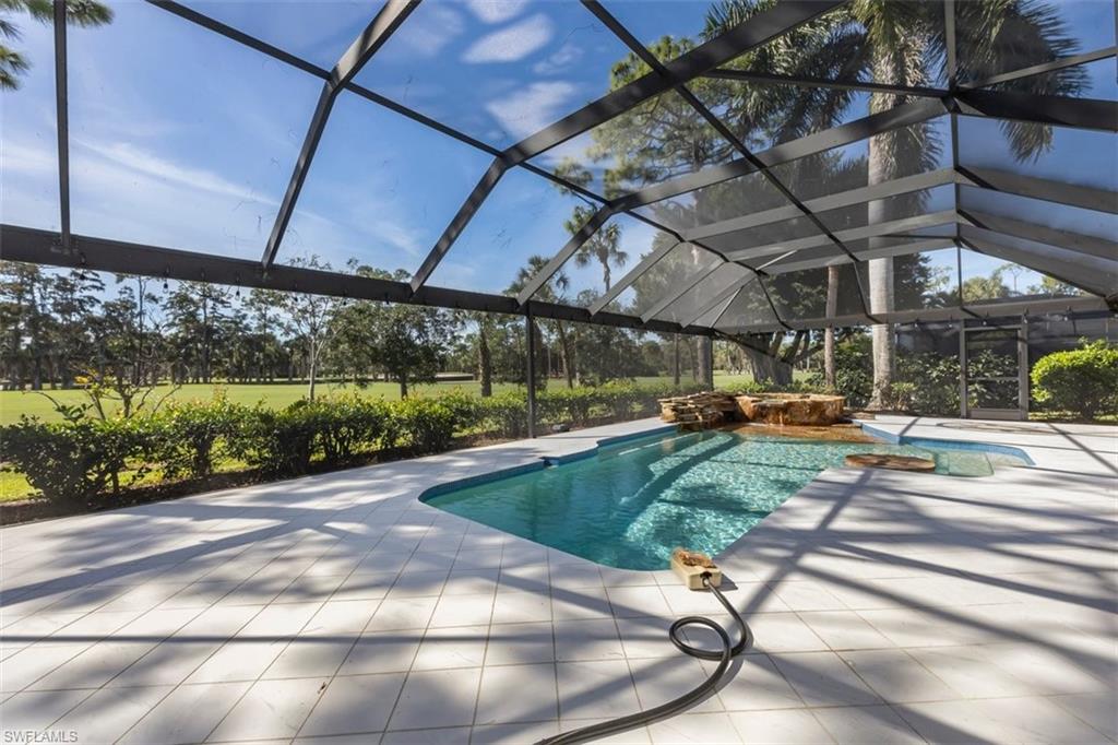 550 Cormorant Cove Naples, FL 34113 - Photo 11 of 39 a view of a swimming pool with a patio