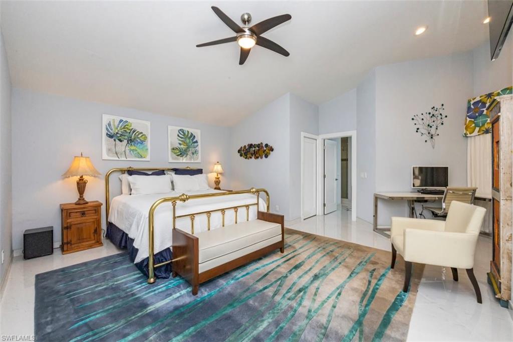 550 Cormorant Cove Naples, FL 34113 - Photo 15 of 39 a bedroom with a bed and a table