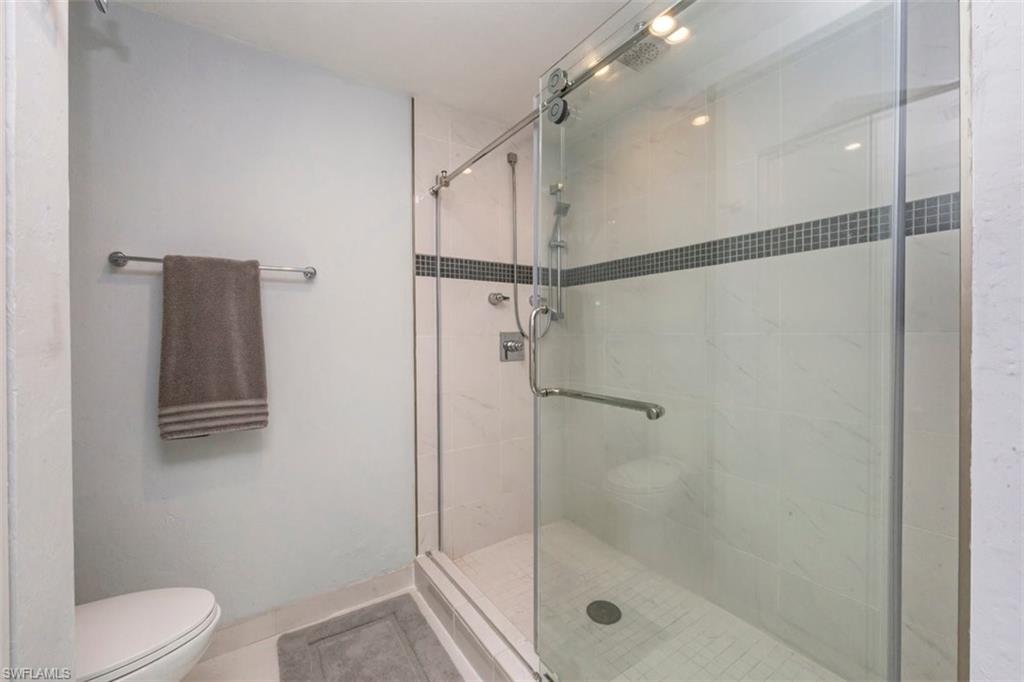 550 Cormorant Cove Naples, FL 34113 - Photo 17 of 39 a bathroom with a shower a toilet and a mirror