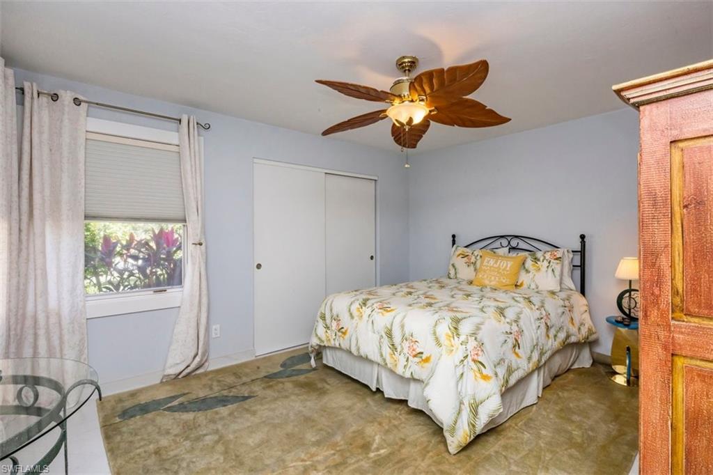 550 Cormorant Cove Naples, FL 34113 - Photo 18 of 39 a bedroom with a bed and a painting on the wall