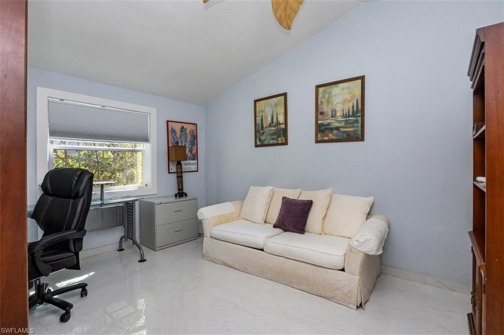 550 Cormorant Cove Naples, FL 34113 - Photo 19 of 39 a living room with furniture and a window