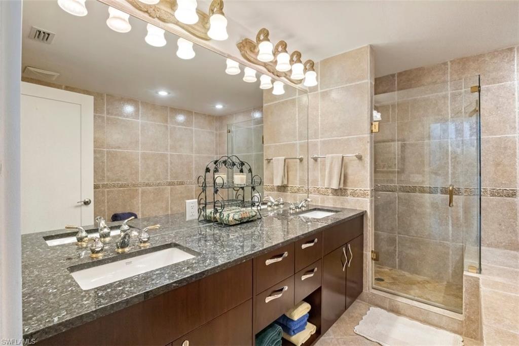 550 Cormorant Cove Naples, FL 34113 - Photo 20 of 39 a bathroom with a sink double vanity and a mirror