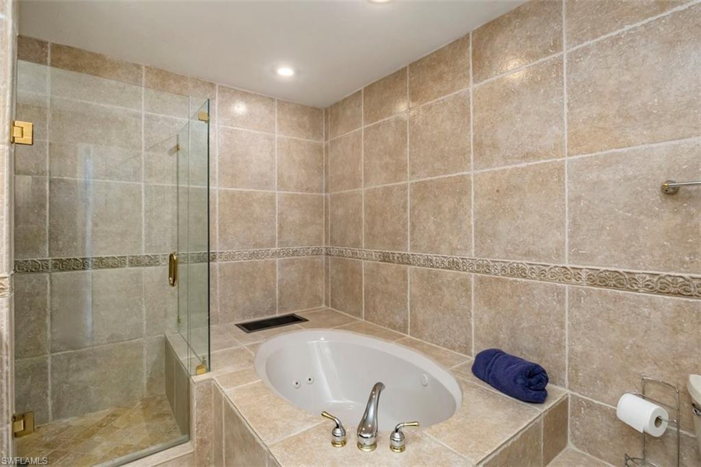 550 Cormorant Cove Naples, FL 34113 - Photo 21 of 39 a bathroom with a shower and a bathtub