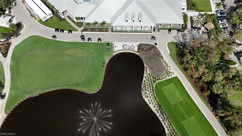 550 Cormorant Cove Naples, FL 34113 - Photo 26 of 39 a view of a swimming pool with outdoor seating and plants