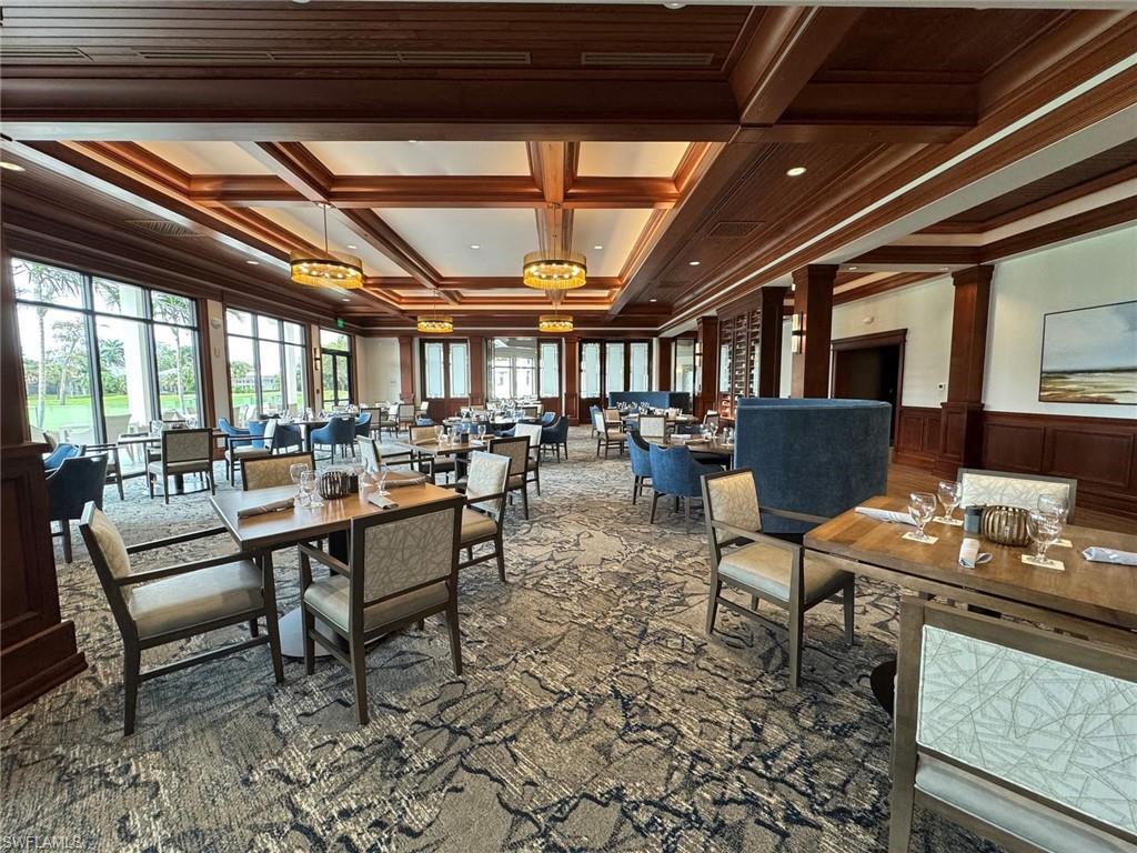 550 Cormorant Cove Naples, FL 34113 - Photo 30 of 39 a living room with lots of furniture and a black umbrella