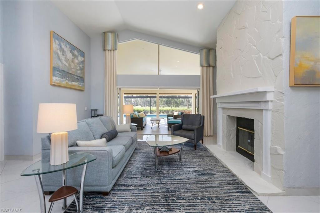 550 Cormorant Cove Naples, FL 34113 - Photo 3 of 39 a living room with furniture fireplace and a table