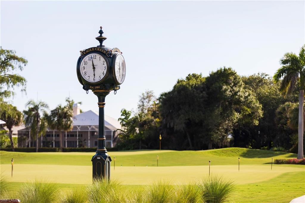 550 Cormorant Cove Naples, FL 34113 - Photo 34 of 39 a view of a swimming pool with a yard and seating area