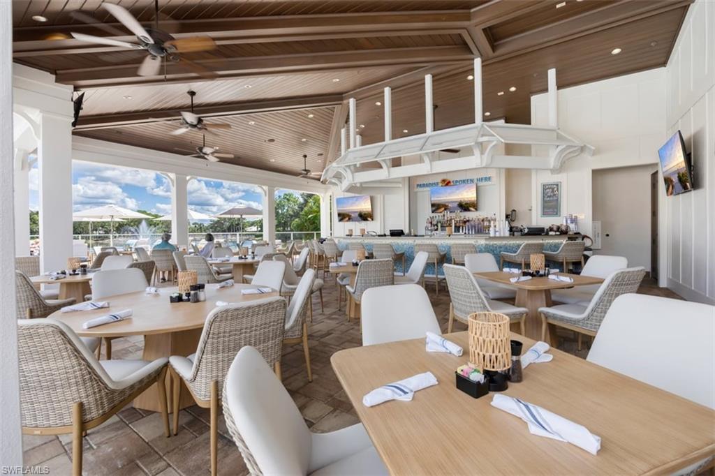 550 Cormorant Cove Naples, FL 34113 - Photo 36 of 39 a large living room with lots of furniture and a large window