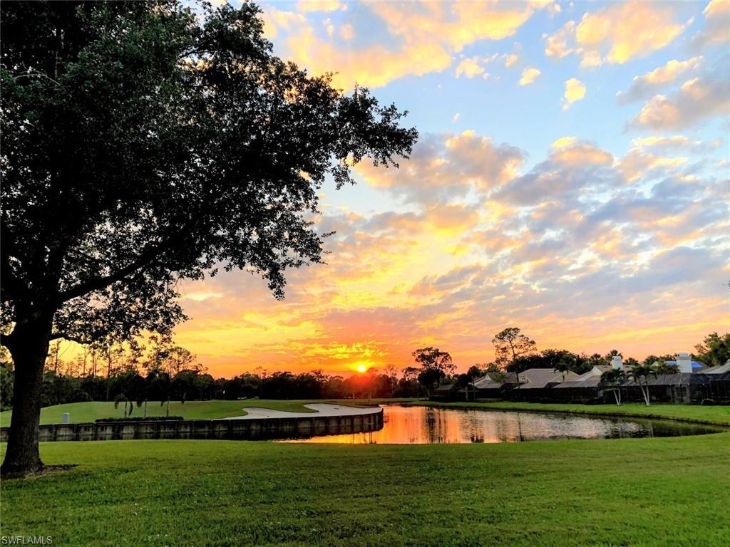 550 Cormorant Cove Naples, FL 34113 - Photo 39 of 39 a view of a lake with houses in the background