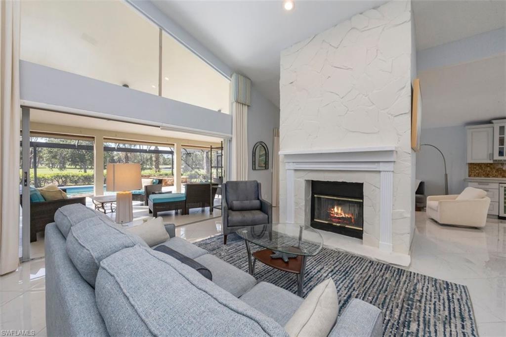 550 Cormorant Cove Naples, FL 34113 - Photo 4 of 39 a living room with furniture and a fireplace