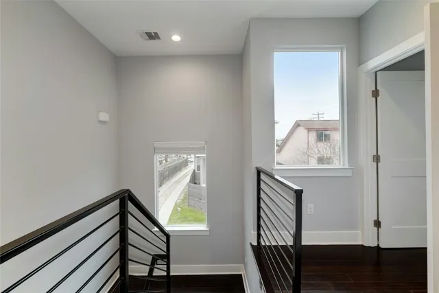 a view of entryway and hall with wooden floor